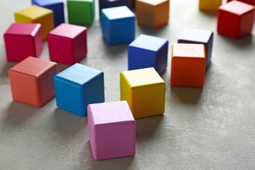 Obraz premium Color cubes on grey background. Unity concept