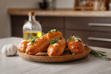 Plate with delicious homemade garlic bread on table