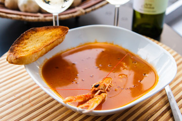 Tomato soup with langoustine and a glass. Beautiful Serving