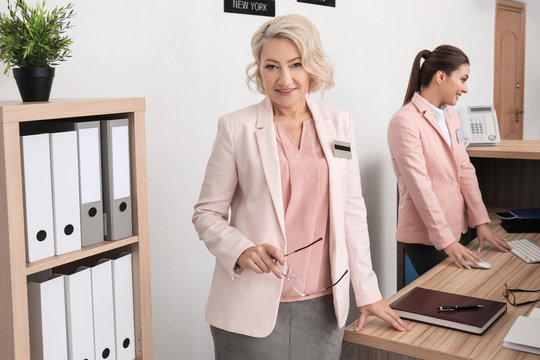Female receptionist with trainee in hotel