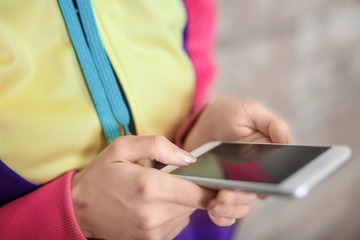 Young woman with mobile phone, closeup