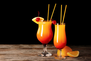 Glasses of Sex on the Beach cocktail against dark background