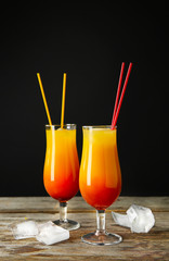 Glasses of Sex on the Beach cocktail against dark background