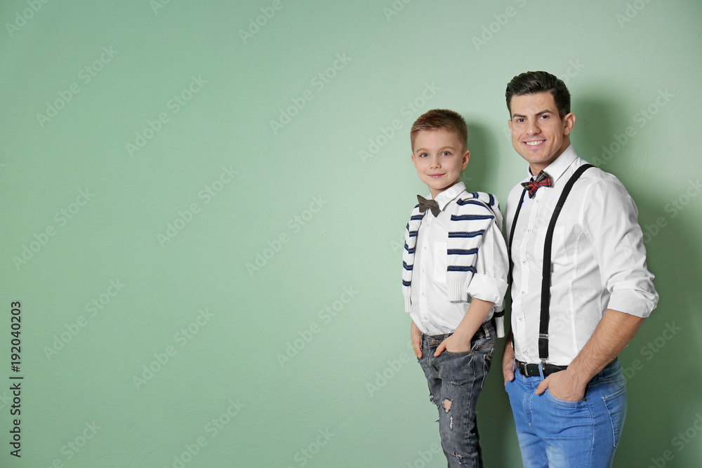 Sticker Stylish father and son on color background