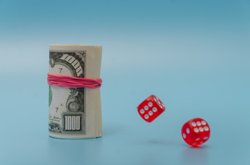 a pack of dollars with dice and a figure of six on a blue background