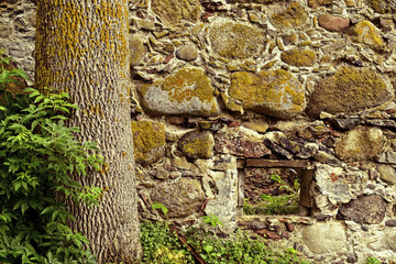 Wall made of natural stone with a small window