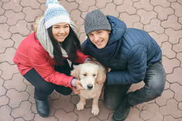 Cute couple with dog outdoors