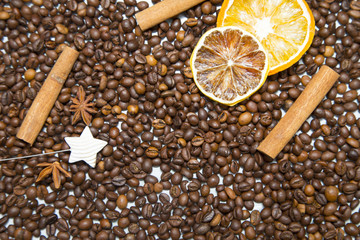 Dried orange, sugar straws and coffee beans on wooden background. Top view