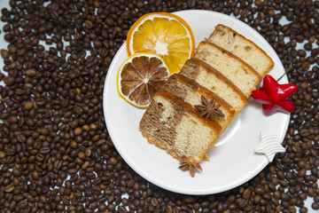 Dried orange and coffee beans on white stone background