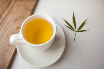 Obraz na płótnie Canvas cannabis tea white cup