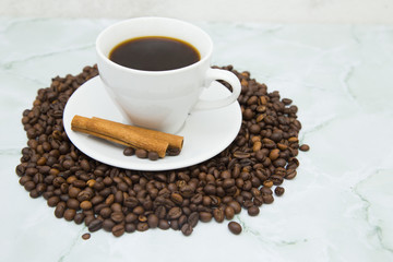 Coffee cup, sugar straws and coffee beans on white stone background