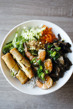 Overhead view of bun thit nuong cha gio served on a plate
