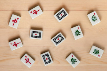 White-green tiles for mahjong on green cloth. dragons