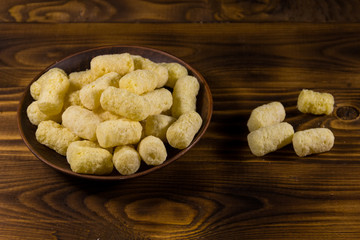 Sweet corn sticks on a plate on wooden table