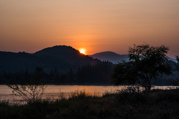 Landscape reservoir and mountain on sunset.