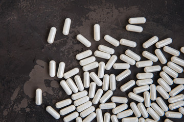 White madicine capsules contain vitamin, drug or nutritional supplement