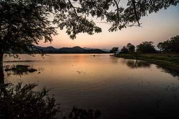 Landscape reservoir and mountain on sunset.