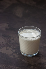 Milk in a glass beaker on a dark background