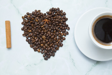 I love coffee concept. A cup, sugar straw and coffee beans on white stone background. Top view