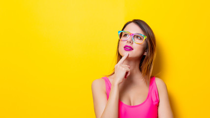 Young girl in pink one-piece swimming suit