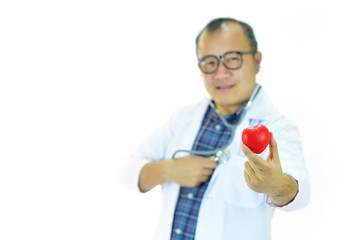Doctor holding heart in hands with stethoscope, heart care concept, focus on heart