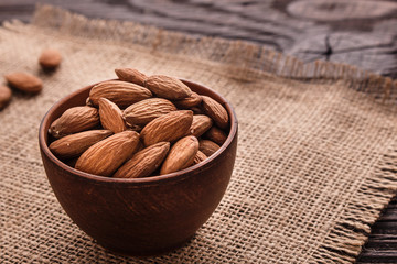 almond essential oil on a wooden background
