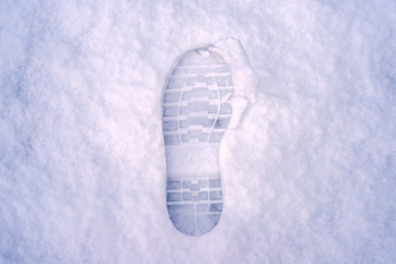 human boot footprint on the snow