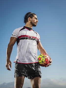 Player holding soccer ball