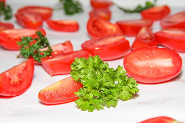 Background made from lot of fresh red sliced tomatoes and fresh herbs