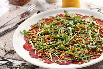 beets with peanuts on white wooden background, breakfast