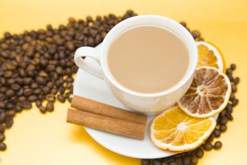 I love coffee concept. Coffee cup, beans and sun dried orange on yellow background