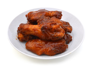 Chicken wings with barbeque sauce in white plate on white