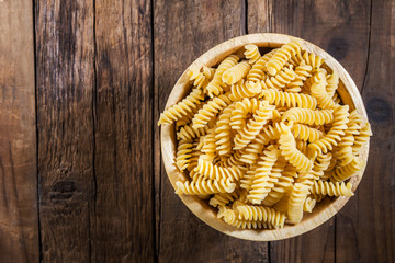 Raw Pasta Fusilli in Wooden Bowl