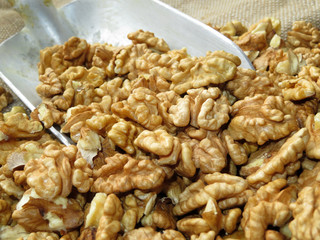 Walnut. Scoop with peeled walnuts on burlap