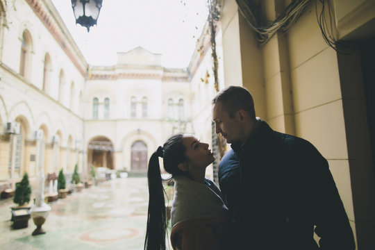 Caucasian couple standing face to face in courtyard