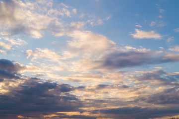 Naklejka na ściany i meble Colorful clouds on the blue sky at sunset or sunrise