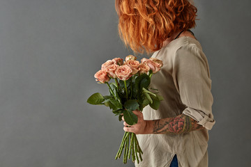 young girl holding a bouquet of pink flowers