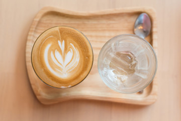 coffee cup latte art on a wooden table in a coffee shop. top view