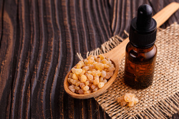 frankincense essential oil on a wooden background