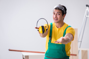 Worker showing the importnace of wearing noise cancelling headph