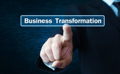 Man hand pressing on Business Transformation text on screen.