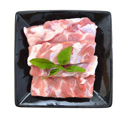 Raw Pork Ribs Isolated in black plate On White Background