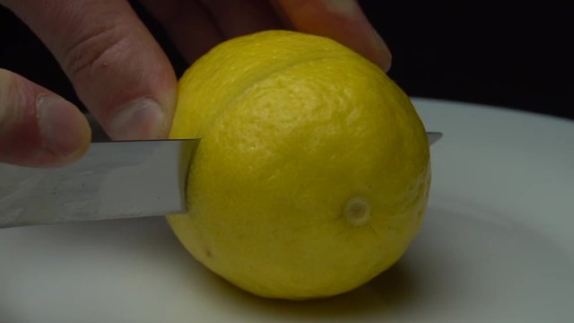 Cutting lemon on the white plate