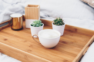 Coffee cup on tray. Styled morning at home