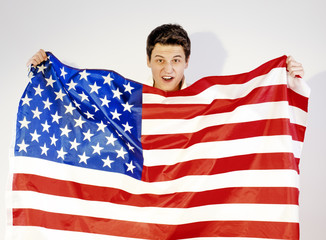 Brunette fan holding USA flag on gray background