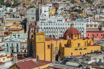 Looking down on a UNESCO Heritage Site-Guanajuato City, Mexico, from up on a hill, with a view of the Basilica, Guanajuato University, many other buildings and colorful houses - 192049044