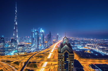 Dubai skyline after the sunset with beautiful city center lights and Sheikh Zayed road traffic,...