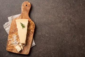 Gartenposter Parmesan cheese on wooden cutting board © ffphoto