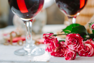 Flowers and glasses of wine on celebration of Valentine's day
