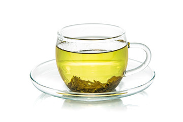 Transparent glass cup of natural green tea isolated on a white background in close-up 